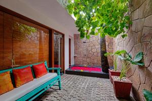 a bench sitting on a patio with a window at The Park Visakhapatnam in Visakhapatnam