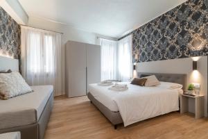 Postel nebo postele na pokoji v ubytování Hotel Grifoni