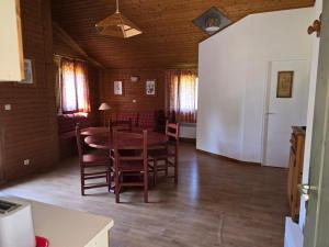 a dining room with a wooden table and chairs at CHALET 6 Personnes in Uxelles +20 photos