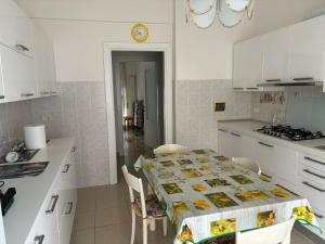 a kitchen with a table with a table cloth on it at Casa vacanze di Carla in Savona