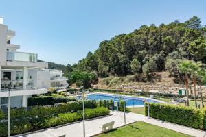 a view of the pool from the balcony of a building at Modern 3 Bedroom Retreat in Benahavís in Benahavís