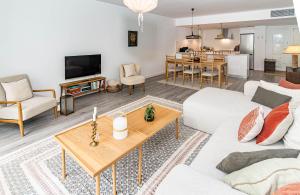 a living room with a white couch and a table at Modern 3 Bedroom Retreat in Benahavís in Benahavís