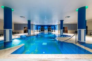 a large pool with blue water in a building at Pestana Sintra Golf Resort & SPA Hotel in Sintra