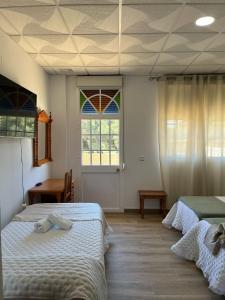 Postel nebo postele na pokoji v ubytování Hostal Quinto Pino