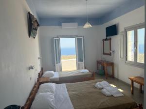 Rúm í herbergi á Hotel Hellas