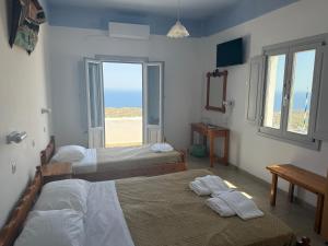 Rúm í herbergi á Hotel Hellas