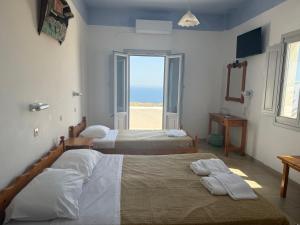 Rúm í herbergi á Hotel Hellas