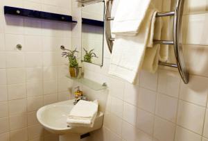 a bathroom with a sink and a mirror and towels at Au Pont Romain Gites in Caunes-Minervois +45 photos