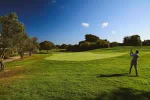 a man flying a kite on a golf course at Pestana Sintra Golf Resort & SPA Hotel in Sintra