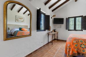 A bed or beds in a room at Boutique B&B Cortijo Valverde Álora