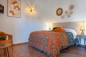 A bed or beds in a room at Boutique B&B Cortijo Valverde Álora