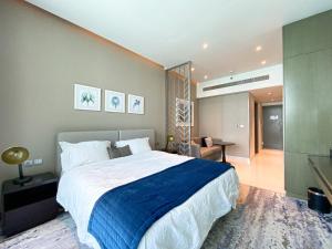 a bedroom with a large bed and a living room at Vista Chic Studio in Prive By Damac-14 in Dubai +10 photos