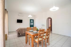 a living room with a table and chairs and a couch at Giannis Holiday House 2 in Vitalades