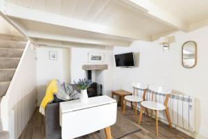 a living room with a couch and a table at The Bakehouse in Port Isaac +14 photos