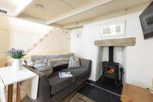 a living room with a couch and a fireplace at The Bakehouse in Port Isaac