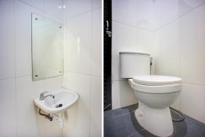 a bathroom with a toilet and a sink at Dancenter Helvetia Near Plaza Millenium Formerly Sunny Inn in Medan +21 photos