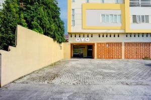 an entrance to an office building with a building at Dancenter Helvetia Near Plaza Millenium Formerly Sunny Inn in Medan