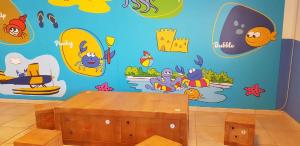 a room with a blue wall with surfboards on it at Camping Blu Fantasy in Senigallia