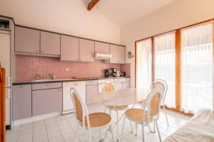 eine Küche mit Tisch und Stühlen in einem Zimmer in der Unterkunft Villa bord de mer in Gruissan