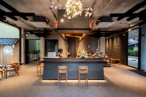 a bar in a restaurant with chairs and tables at Hoshi Hotel Hatyai in Hat Yai