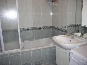 a bathroom with a sink and a bath tub next to a sink at kutlesa 2 in Opatija +22 photos
