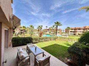 马拉喀什Prestigia Luxury Appart 2 Room的庭院配有桌椅和庭院。