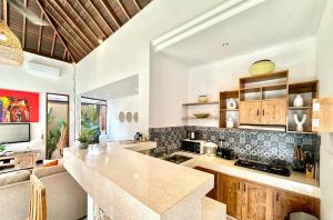a kitchen with a large island in a room at Villa Searenity Seminyak in Seminyak