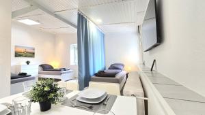 a living room with two couches and a tv at -CS24- 1 room Apartment with terrace - ALT03 in Altena