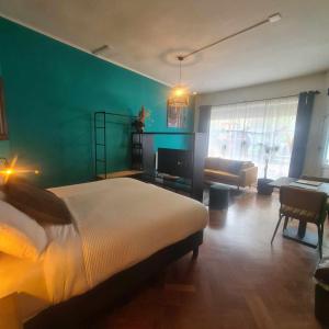 a bedroom with a bed and a living room at Feel at Home - Holiday Studio in Gulpen