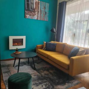 a living room with a couch and a table at Feel at Home - Holiday Studio in Gulpen