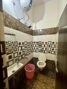 a bathroom with a toilet and a sink at Hotel PB02 Inn in Amritsar