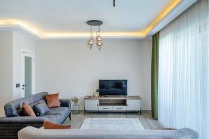 a living room with a couch and a tv at Villa Zero in Fethiye
