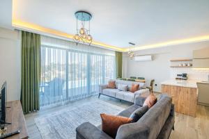 a living room with a couch and a kitchen at Villa Zero in Fethiye