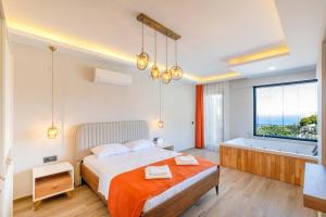 a hotel room with a bed and a bath tub at Villa Zero in Fethiye +21 photos
