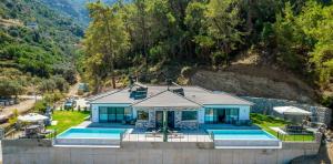 an aerial view of a house with a swimming pool at Villa Zero in Fethiye