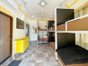 a room with bunk beds and a desk in it at The Hosteller Udaipur in Udaipur