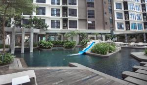 a pool in the middle of a building with a water slide at Sfera Residence Kuala Lumpur City Centre in Kuala Lumpur