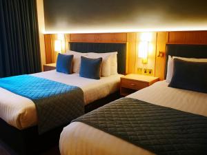 En eller flere senger på et rom på Lancaster Lodge