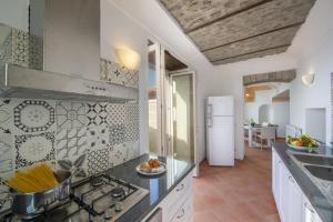 a kitchen with a stove and a counter top at Villa Cimino - for walking lovers! in Praiano
