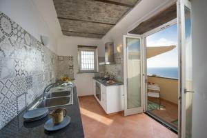 a kitchen with a sink and a counter top at Villa Cimino - for walking lovers! in Praiano +30 photos