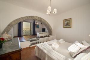 a bedroom with a large bed and an archway at Villa Cimino - for walking lovers! in Praiano