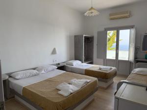 Rúm í herbergi á Hotel Hellas