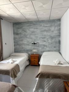 Postel nebo postele na pokoji v ubytování Hostal Quinto Pino
