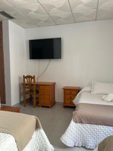 Postel nebo postele na pokoji v ubytování Hostal Quinto Pino