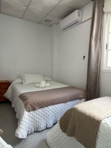 Postel nebo postele na pokoji v ubytování Hostal Quinto Pino
