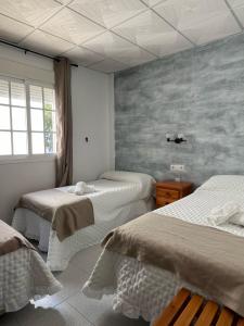 Postel nebo postele na pokoji v ubytování Hostal Quinto Pino