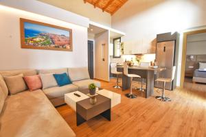 a living room with a couch and a table at Oras Corfu Contessa in Áno Korakiána