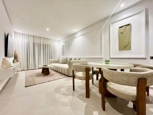 a living room with a couch and a table and chairs at Marrakech golf City prestigia in Marrakesh