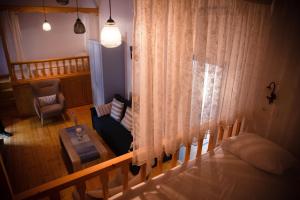 a bedroom with a bed and a couch and a table at The Water Mill Cottage in Lagoúdi Zía +28 photos