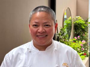 a man in a chef outfit smiling at the camera at Hotel Sofitel Los Angeles at Beverly Hills in Los Angeles